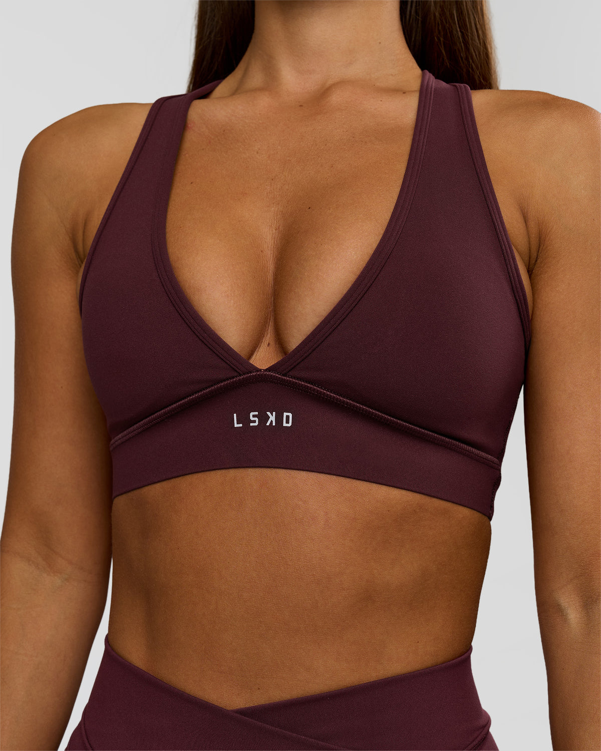 Woman wearing Stamina Sports Bra - Cherry Lacquer | Model:Brylee | Size:XS - view 1