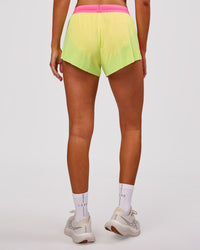 Woman wearing Accelerate 3" Mid-Rise Running Short - Lime Glo-Sugar Plum | Model:Charli | Size:XS | Thumbnail Index: 5