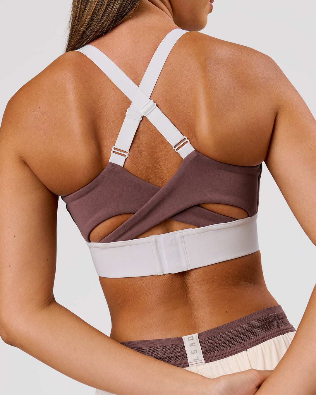 Woman wearing Elevated Accelerate Sports Bra - Cocoa Power-White | Model:Charli | Size:XS - view 3