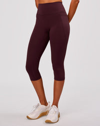 Woman wearing Fusion V Contour Ultra High-Rise 3/4 Legging Pockets - Cherry Lacquer | Model:Charli | Size:XS | Thumbnail Index: 1