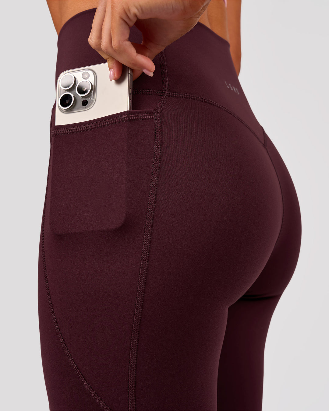 Woman wearing Fusion V Contour Ultra High-Rise 3/4 Legging Pockets - Cherry Lacquer | Model:Charli | Size:XS - view 3
