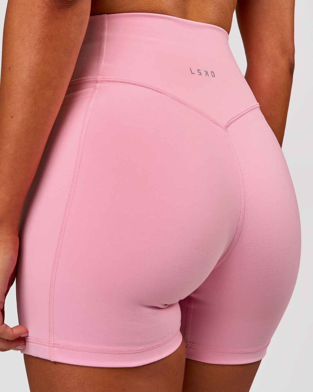 Woman wearing Fusion V-Contour Ultra High-Rise 4" Short Pockets - Pink Rose | Model:Charli | Size:XS - view 2
