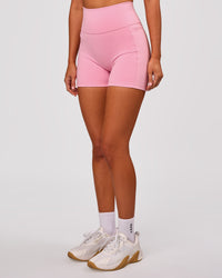 Woman wearing Fusion V-Contour Ultra High-Rise 4" Short Pockets - Pink Rose | Model:Charli | Size:XS | Thumbnail Index: 5