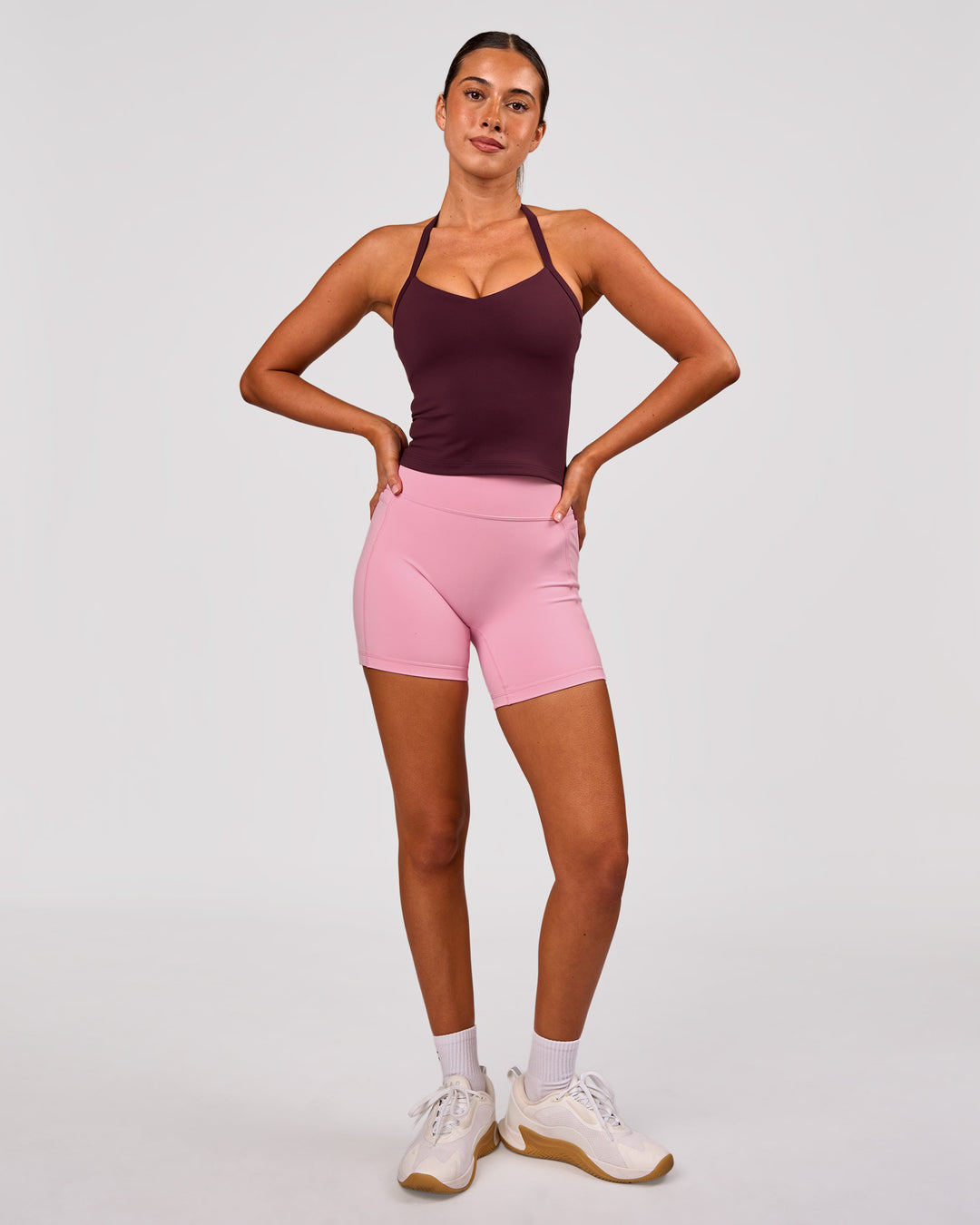 Woman wearing Fusion V-Contour Ultra High-Rise 6" Short Pockets - Pink Rose | Model:Charli | Size:XS - view 2