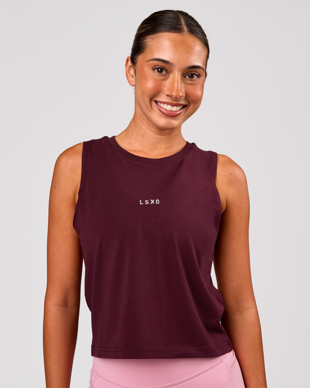 Woman wearing Go-To FLXCotton Midline Tank - Cherry Lacquer-White | Model:Charli | Size:XS - view 1
