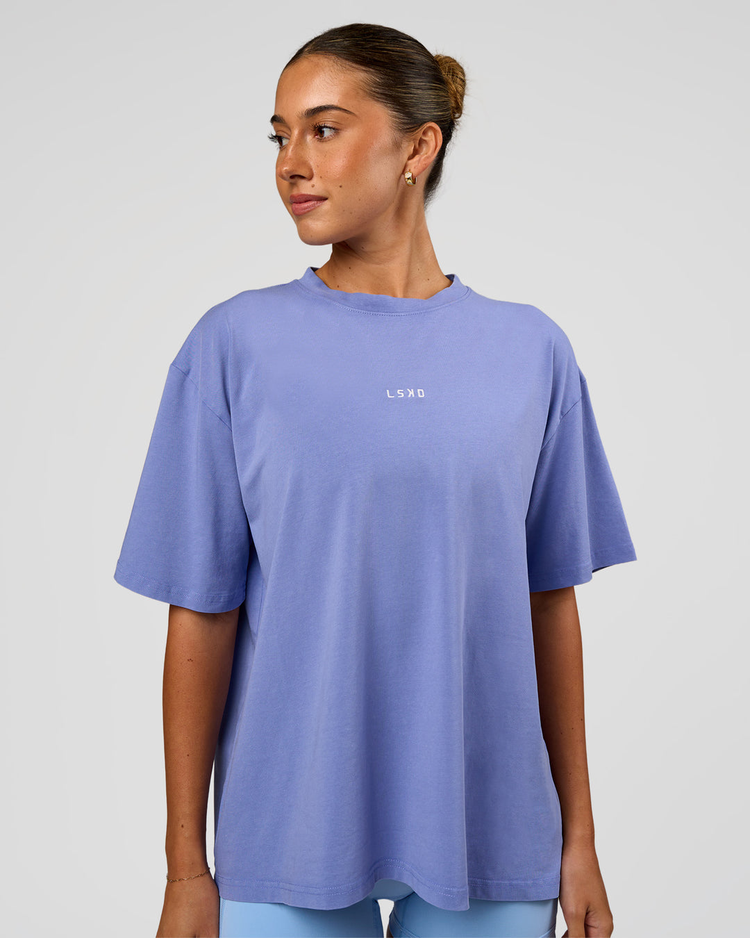 Woman wearing Go-To FLXCotton Oversized Tee - Bluebell Washed-White | Model:Charli | Size:XS - view 1