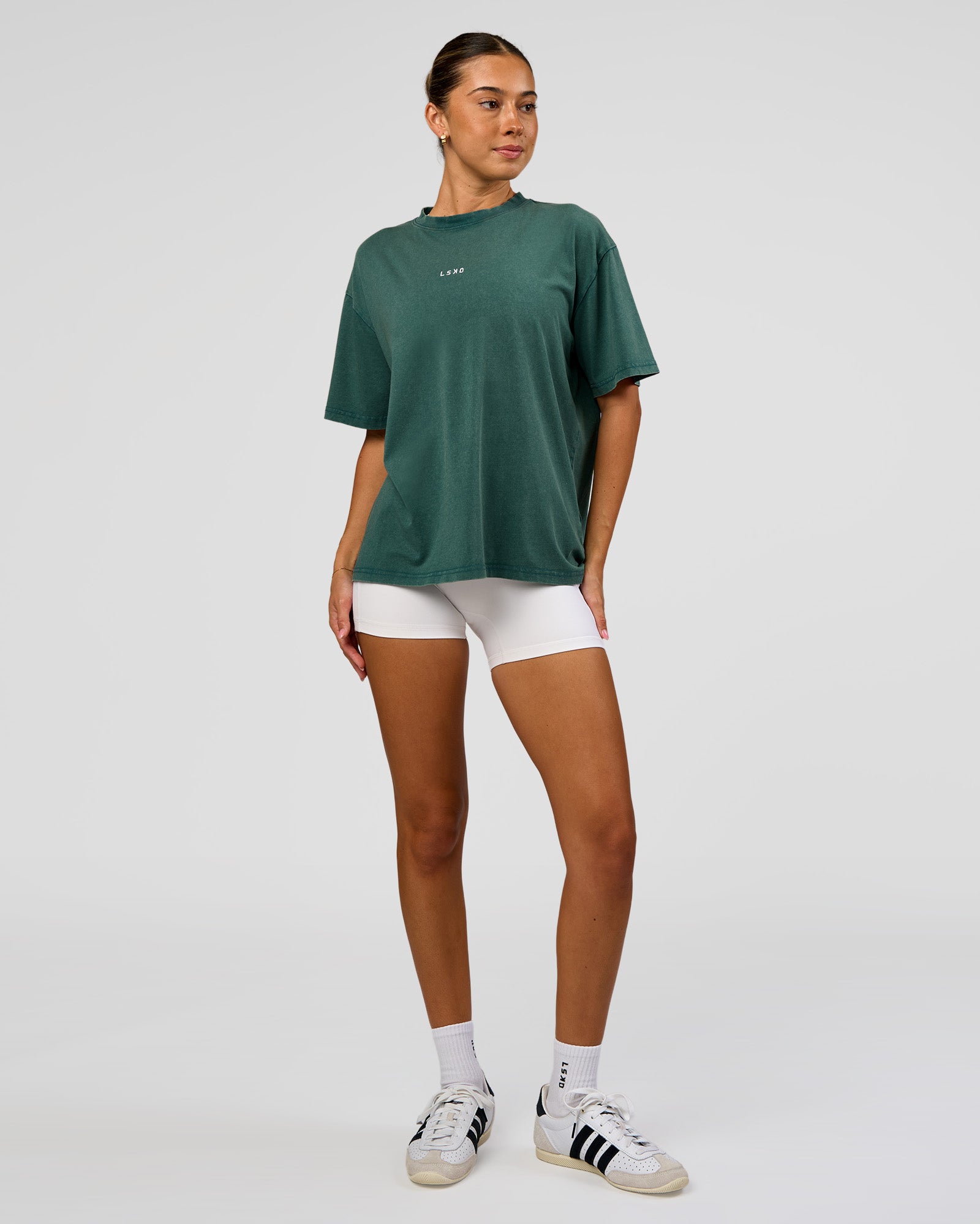 Woman wearing Go-To FLXCotton Oversized Tee - Transformative Teal Washed-White | Model:Charli | Size:XS