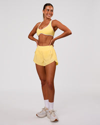 Woman wearing Luminous Sports Bra - Lemon-White | Model:Charli | Size:XS | Thumbnail Index: 4