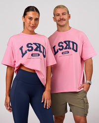 Woman wearing Varsity EST Heavyweight Oversized Tee  - Pink Rose-Future Navy | Model:Charli | Size:XS | Thumbnail Index: 0