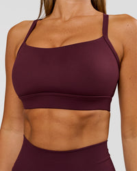 Woman wearing Momentum Sports Bra D/DD/E - Cherry Lacquer | Model:Charli | Size:XS | Thumbnail Index: 0