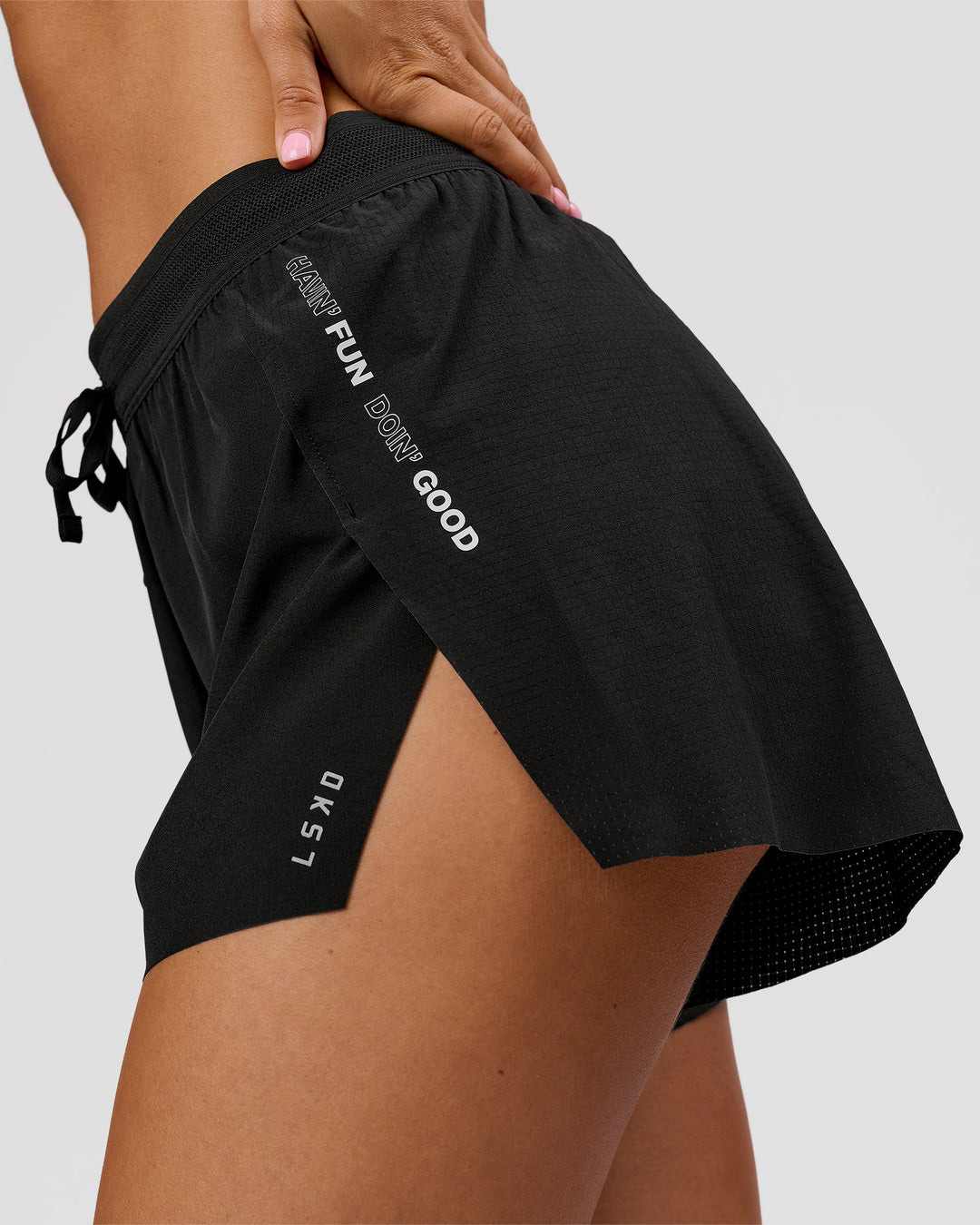 Woman wearing Movember x LSKD Accelerate 3" High-Rise Running Short - Black | Model:Charli | Size:XS - view 3