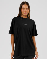 Woman wearing Movember x LSKD FLXCotton Oversize Tee - Black-White | Model:Charli | Size:XS | Thumbnail Index: 5