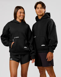 Woman wearing Movember x LSKD Oversized Hoodie - Black | Model:Charli | Size:XS | Thumbnail Index: 0