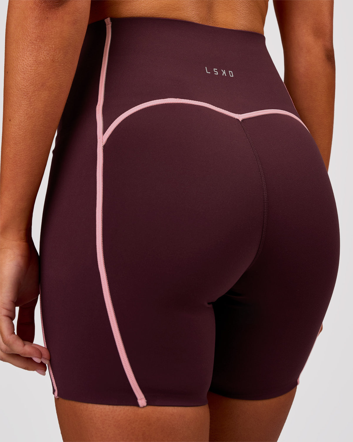 Woman wearing Power Ultra High-Rise 6" Short Pockets - Cherry Lacquer-Pink Rose | Model:Charli | Size:XS
