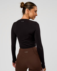 Woman wearing Staple Long Sleeve Cropped Tee 2.0 - Black | Model:Charli | Size:XS | Thumbnail Index: 1