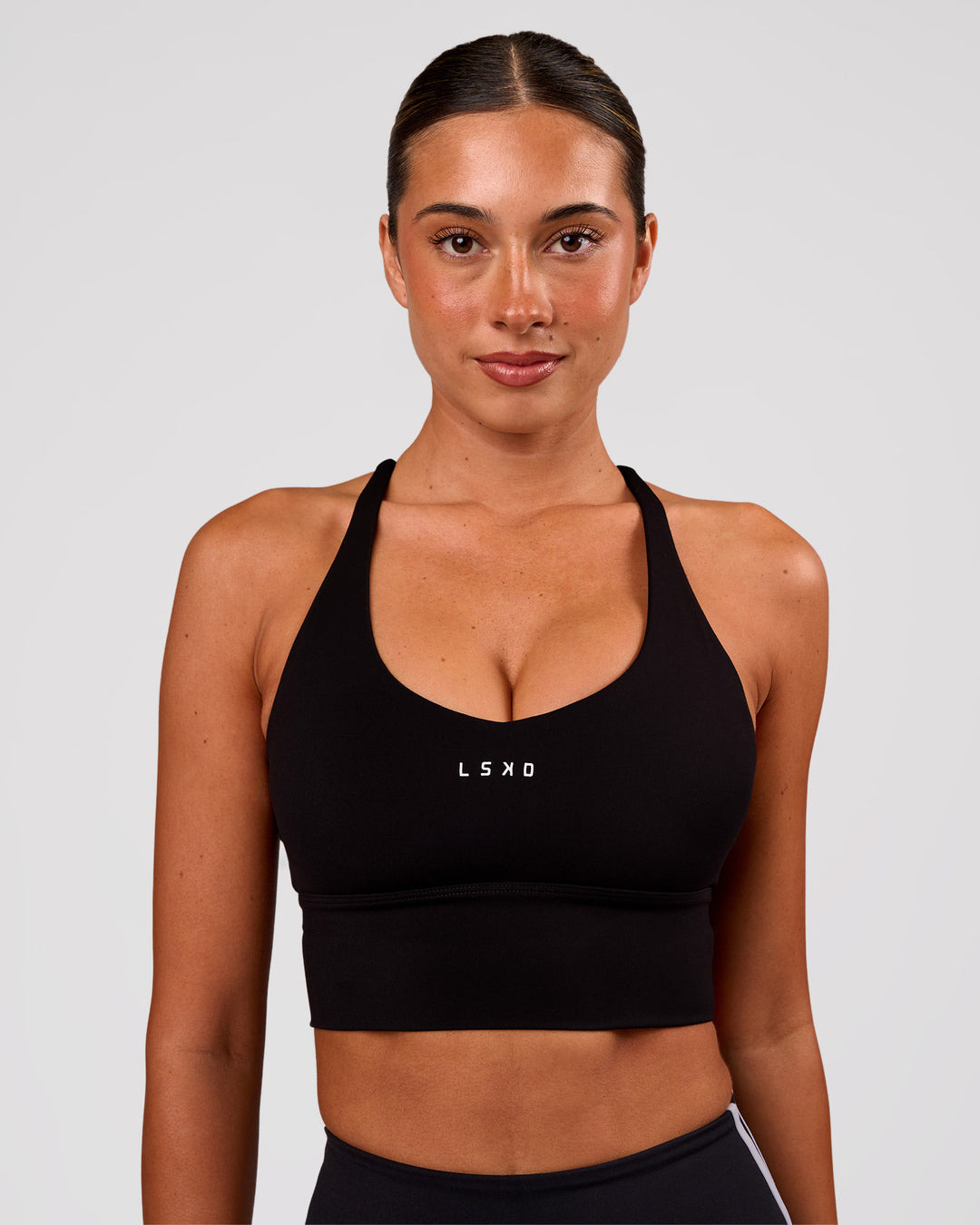 Woman wearing Stellar Long Line Sports Bra - Black-White | Model:Charli | Size:XS - view 1