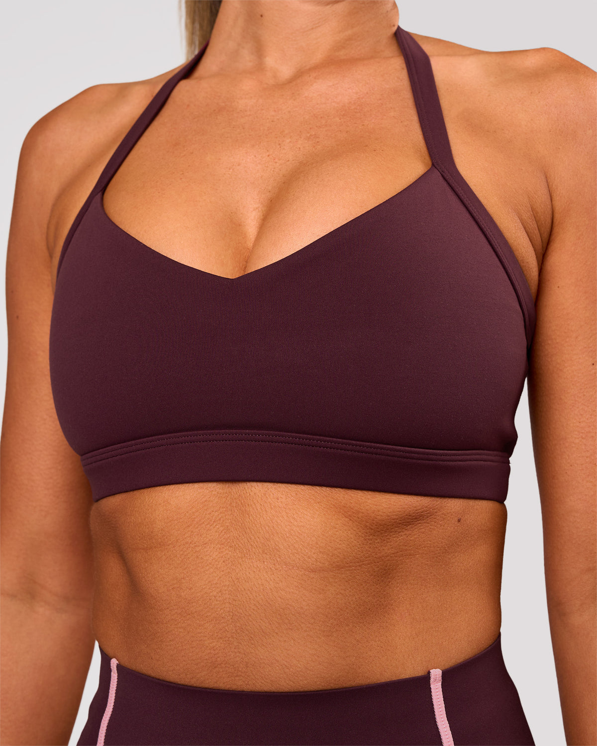 Woman wearing Unleash Sports Bra - Cherry Lacquer | Model:Charli | Size:XS