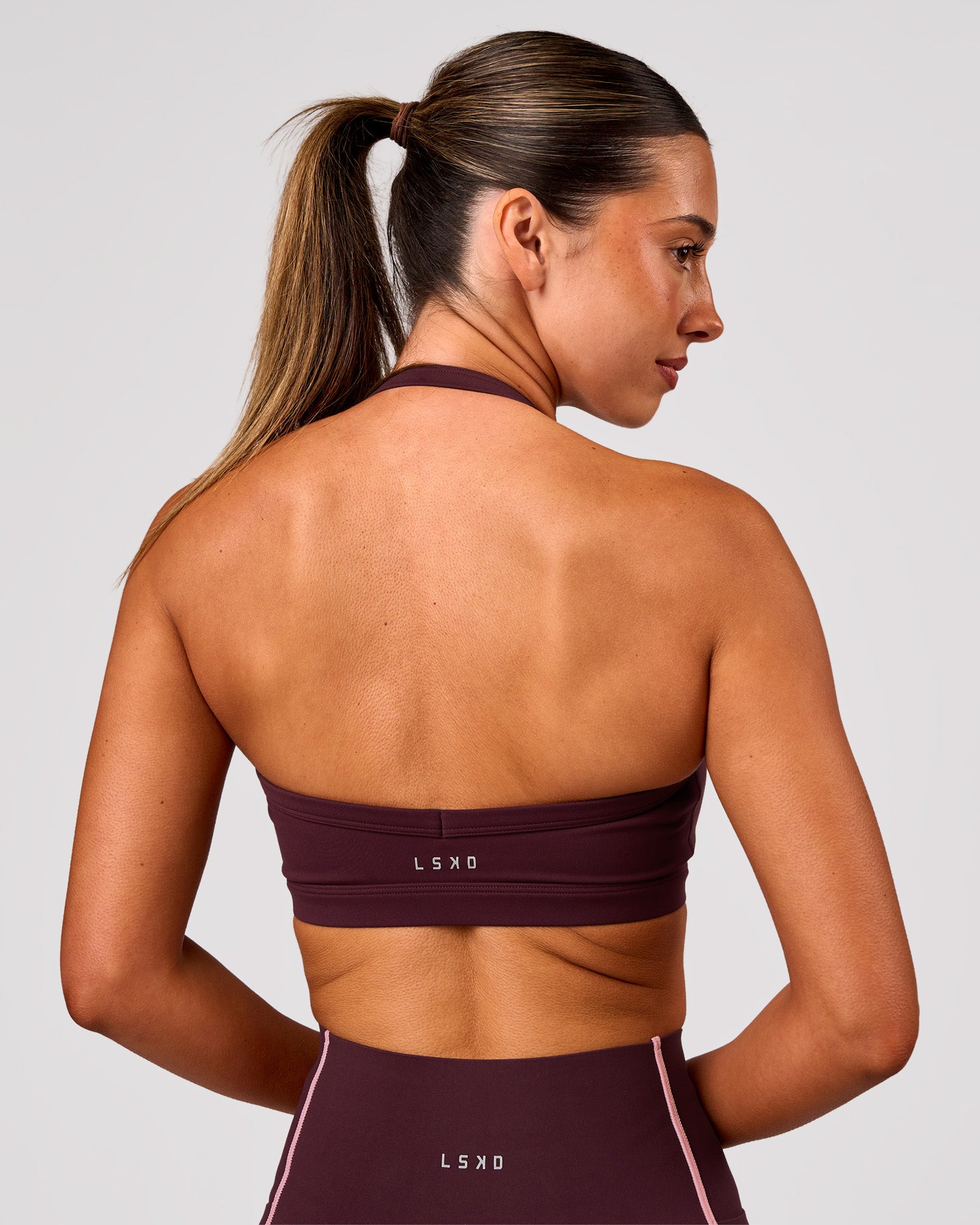 Woman wearing Unleash Sports Bra - Cherry Lacquer | Model:Charli | Size:XS
