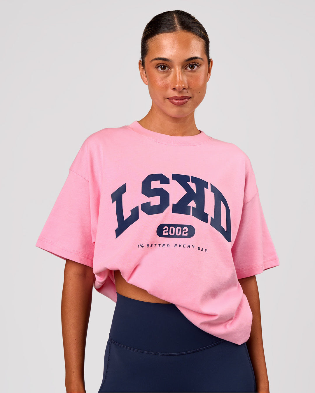 Woman wearing Varsity EST Heavyweight Oversized Tee  - Pink Rose-Future Navy | Model:Charli | Size:XS - view 3