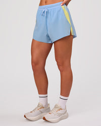 Woman wearing Accelerate 3" Force High-Rise Running Short - Open Air-Lemon | Model:Issy | Size:XS | Thumbnail Index: 4