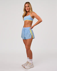 Woman wearing Accelerate 3" Force High-Rise Running Short - Open Air-Lemon | Model:Issy | Size:XS | Thumbnail Index: 6