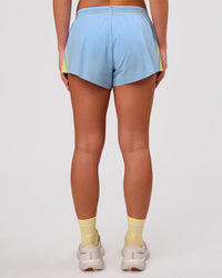 Woman wearing Accelerate 3" Force Mid-Rise Running Short - Open Air-Lemon | Model:Issy | Size:XS | Thumbnail Index: 2