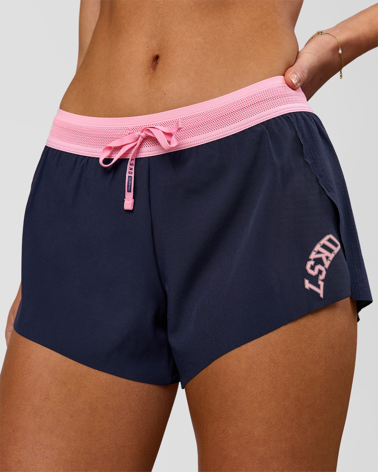 Woman wearing Accelerate 3" Mid-Rise Running Short - Future Navy-Varsity Print | Model:Issy | Size:XS