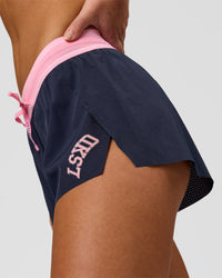 Woman wearing Accelerate 3" Mid-Rise Running Short - Future Navy-Varsity Print | Model:Issy | Size:XS | Thumbnail Index: 3