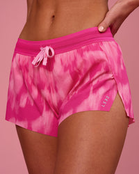 Woman wearing Accelerate 3" Mid-Rise Running Short - Radiant Pink | Model:Issy | Size:XS | Thumbnail Index: 0