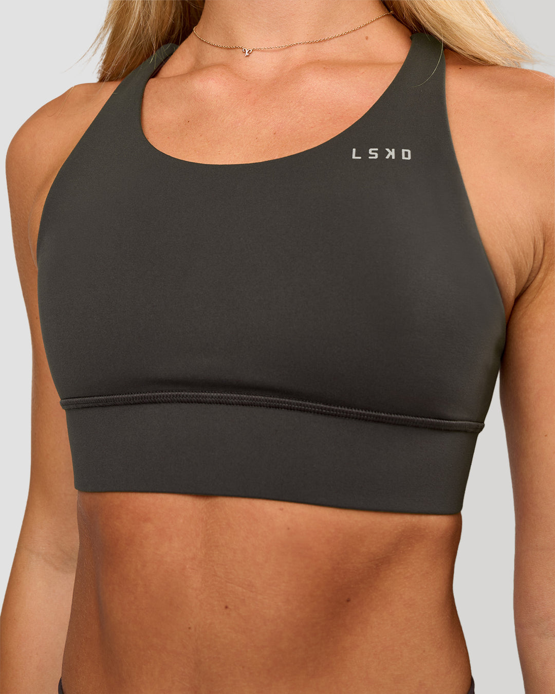 Woman wearing Accelerate Sports Bra - Onyx | Model:Issy | Size:XS - view 1