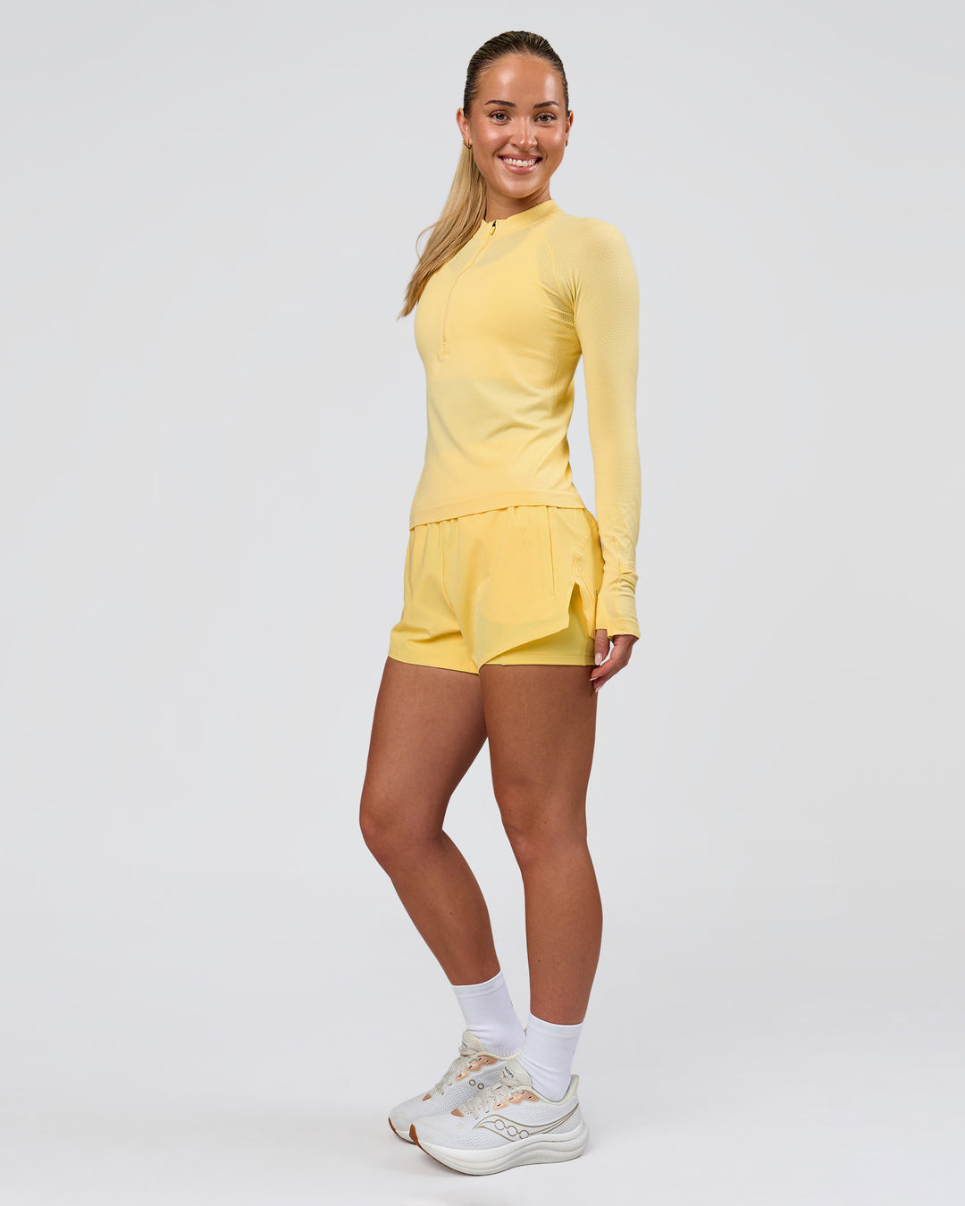 Woman wearing AeroFLX+ Long Sleeve Half Zip - Lemon/Lemon | Model:Issy | Size:XS - view 5