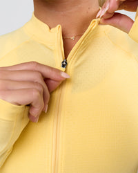 Woman wearing AeroFLX+ Long Sleeve Half Zip - Lemon/Lemon | Model:Issy | Size:XS | Thumbnail Index: 5