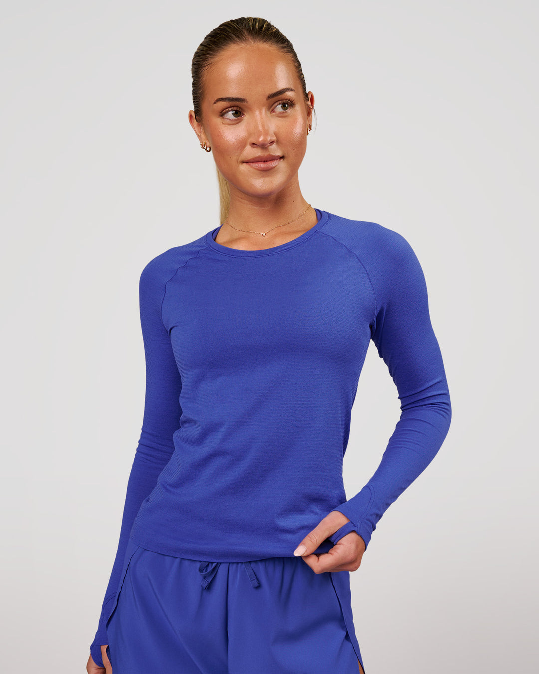 Woman wearing Aeroflx+ Seamless Long Sleeve Tee in Power Cobalt | Model: Issy | Size: XS - view 2