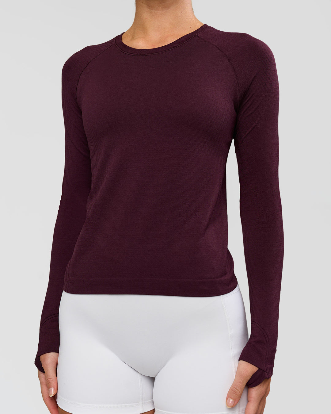 Woman wearing AeroFLX+ Seamless Long Sleeve Tee - Cherry Lacquer/Cherry Lacquer | Model:Issy | Size:XS - view 2