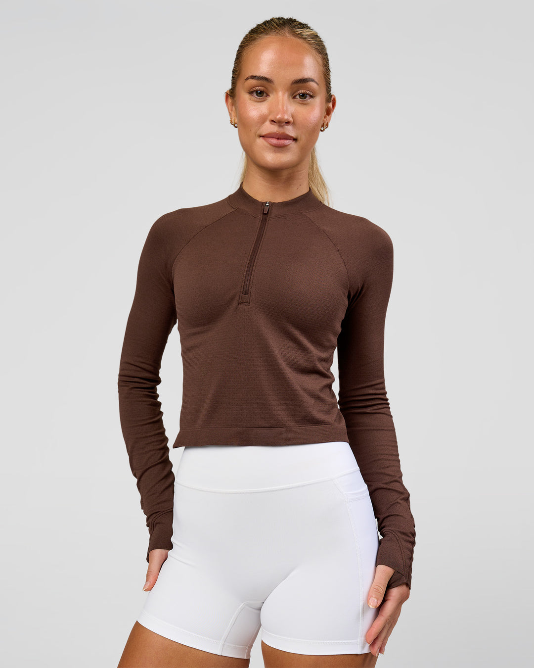 Woman wearing AeroFLX+ Long Sleeve Skimmer Half Zip - Hot Chocolate/Hot Chocolate | Model:Issy | Size:XS - view 6