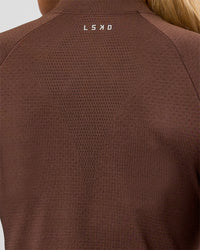 Woman wearing AeroFLX+ Long Sleeve Skimmer Half Zip - Hot Chocolate/Hot Chocolate | Model:Issy | Size:XS | Thumbnail Index: 12