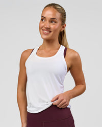 Woman wearing AeroFLX+ Seamless Tank - White/White | Model:Issy | Size:XS | Thumbnail Index: 0