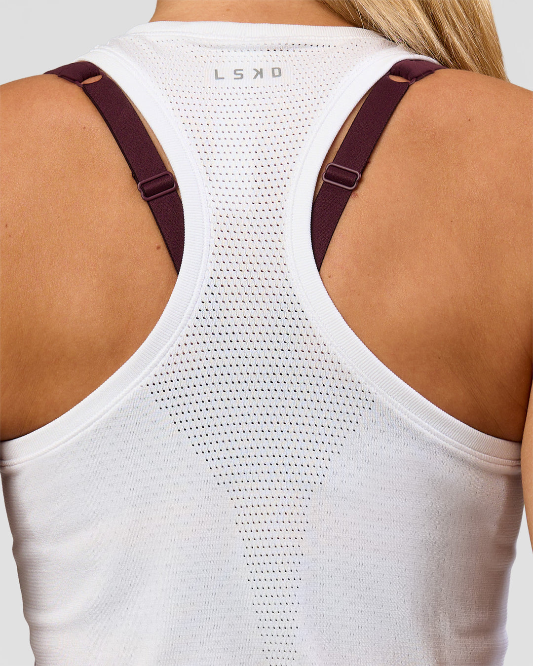Woman wearing AeroFLX+ Seamless Tank - White/White | Model:Issy | Size:XS - view 2