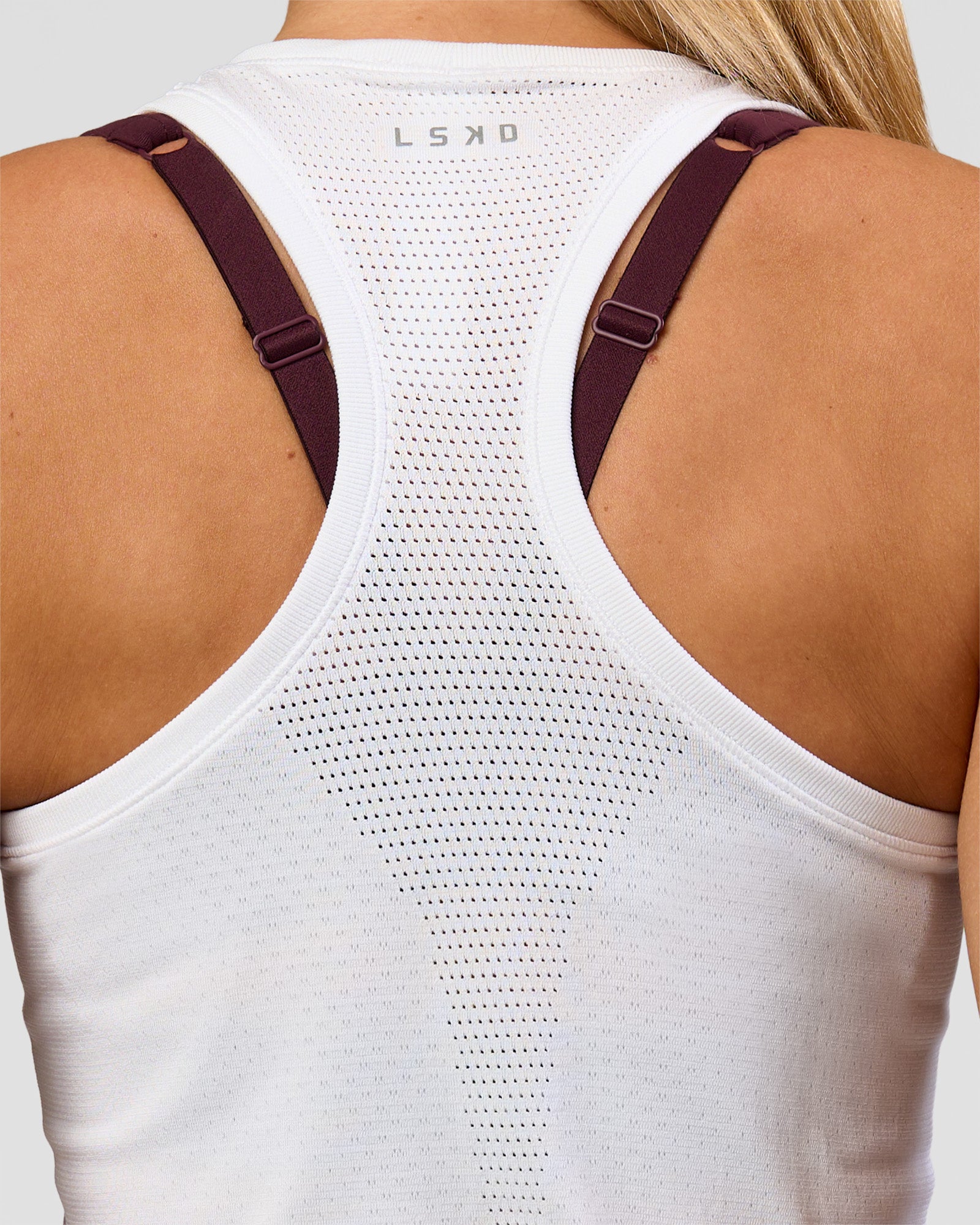 Woman wearing AeroFLX+ Seamless Tank - White/White | Model:Issy | Size:XS
