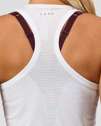 Woman wearing AeroFLX+ Seamless Tank - White/White | Model:Issy | Size:XS | Thumbnail Index: 1