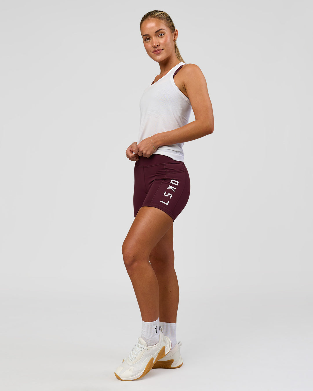 Woman wearing AeroFLX+ Seamless Tank - White/White | Model:Issy | Size:XS - view 6