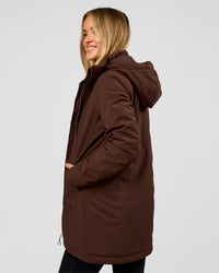 Woman wearing Auxiliary 2.0 Longline Jacket - Hot Chocolate | Model:Issy | Size:XS | Thumbnail Index: 2