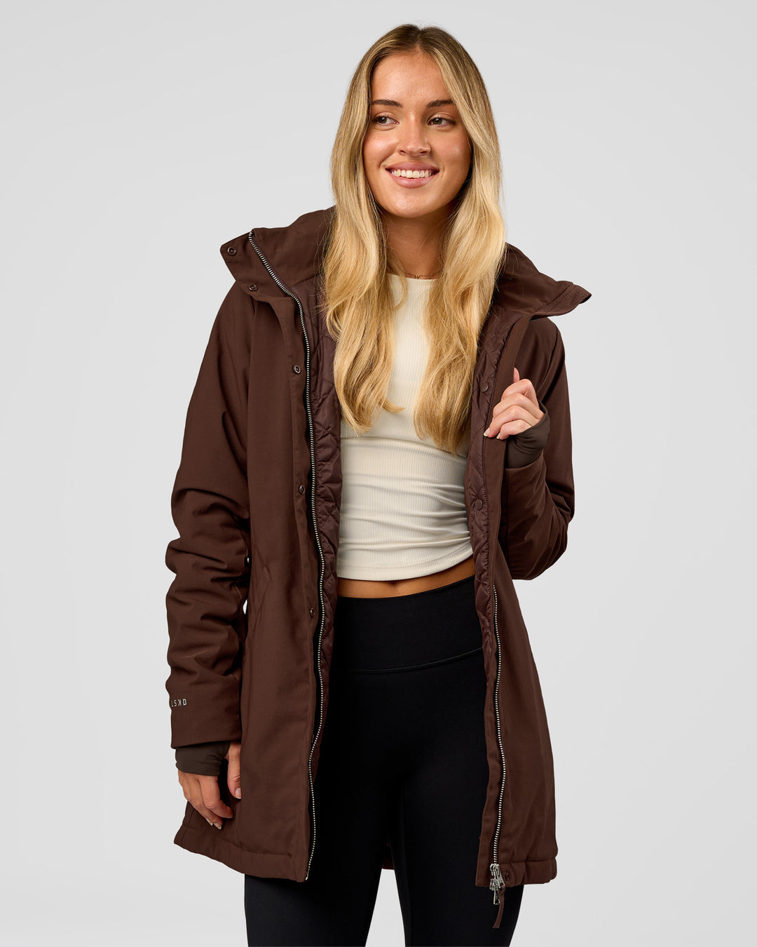Woman wearing Auxiliary 2.0 Longline Jacket - Hot Chocolate | Model:Issy | Size:XS - view 1