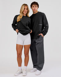 Woman wearing Backline Washed Heavyweight Oversized LS Tee - Black Washed | Model:Issy | Size:XS | Thumbnail Index: 17