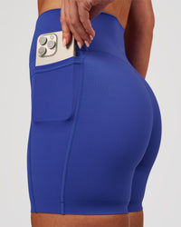 Woman wearing Elixir High-Rise 6" Short Pockets - Power Cobalt | Model:Issy | Size:XS | Thumbnail Index: 0