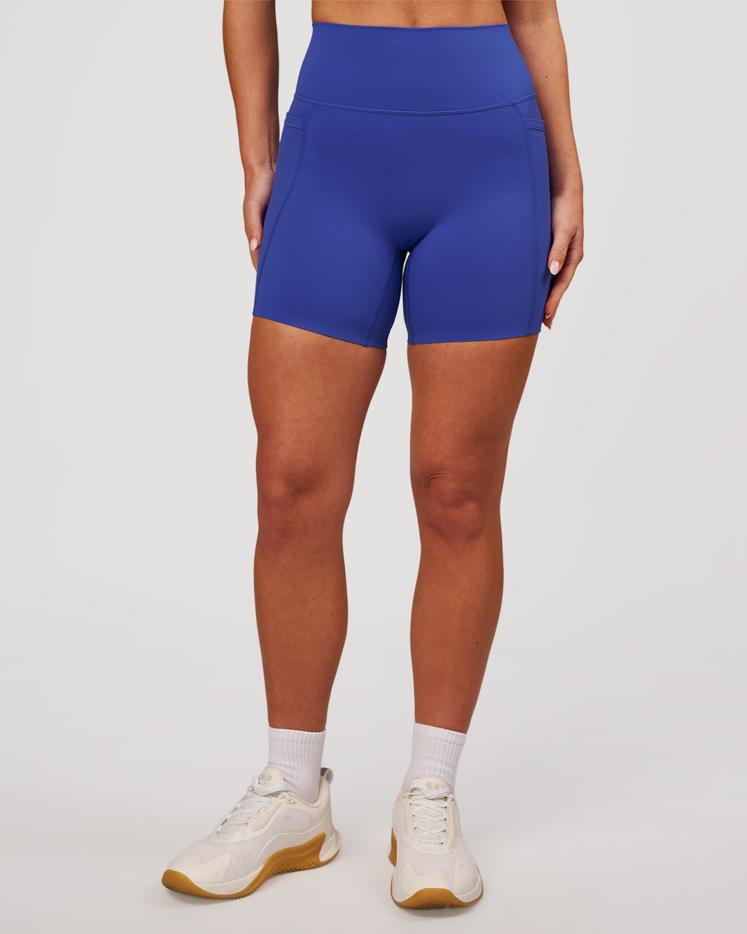 Woman wearing Elixir High-Rise 6" Short Pockets - Power Cobalt | Model:Issy | Size:XS - view 2