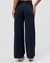 Woman wearing Elixir High-Rise Petite Pant - Midnight Navy | Model:Issy | Size:XS | Thumbnail Index: 3