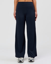 Woman wearing Elixir High-Rise Petite Pant - Midnight Navy | Model:Issy | Size:XS | Thumbnail Index: 8