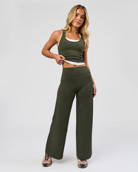 Woman wearing Elixir High-Rise Petite Pant - Pure Olive | Model:Issy | Size:XS | Thumbnail Index: 0