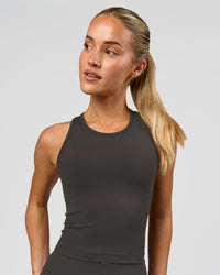 Woman wearing Flow Performance Tank 2.0 - Onyx | Model:Issy | Size:XS | Thumbnail Index: 0